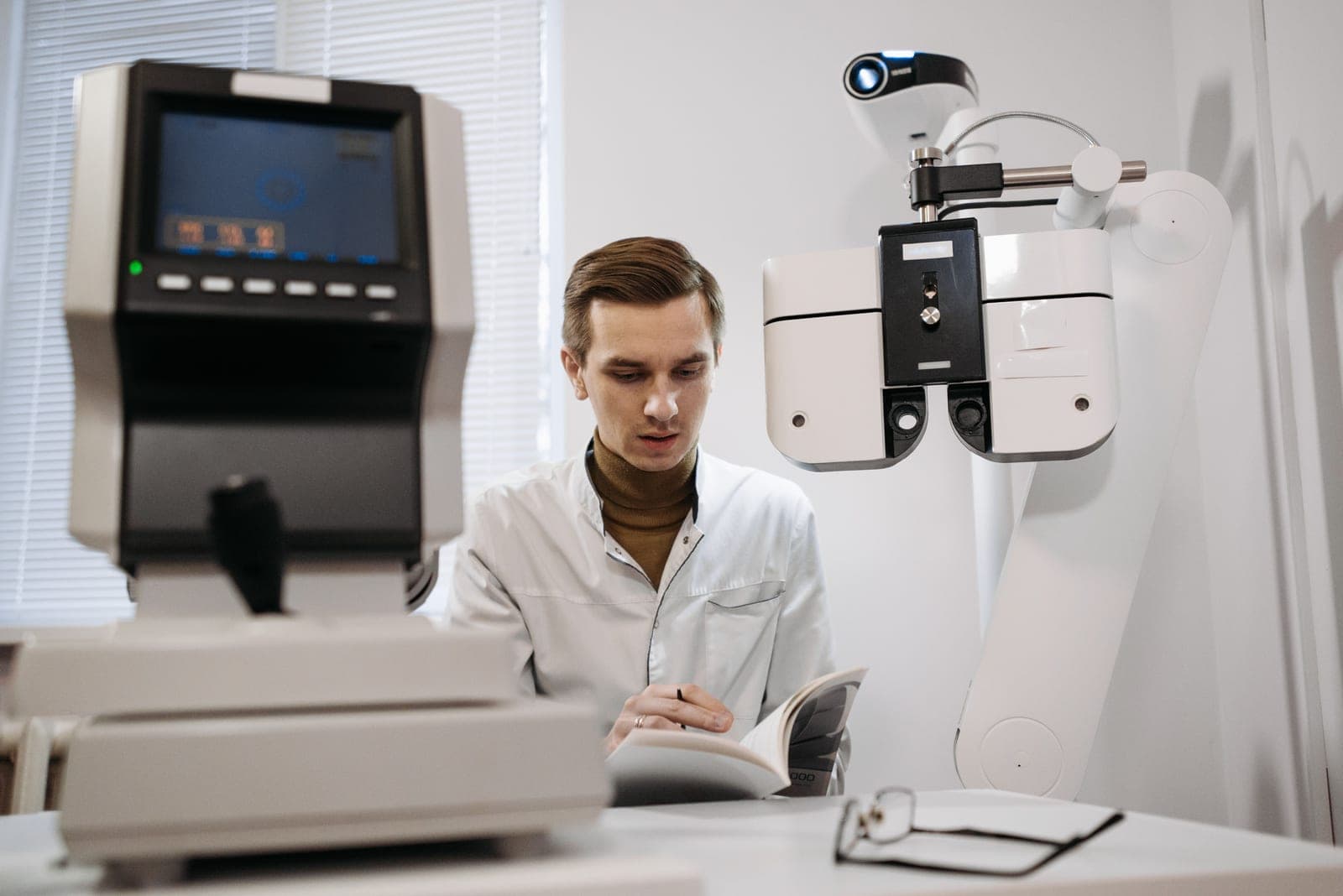 A person reading a technical manual at a desk