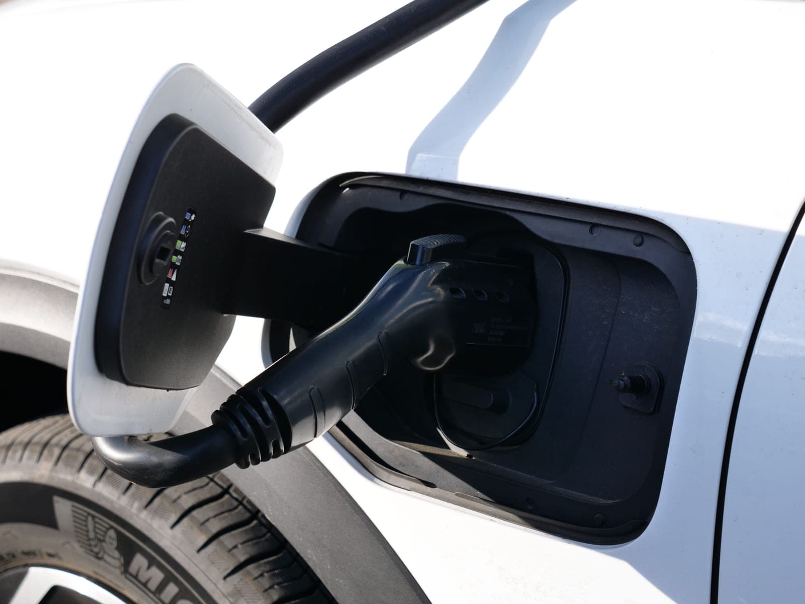 Two electric vehicle charging connectors side by side