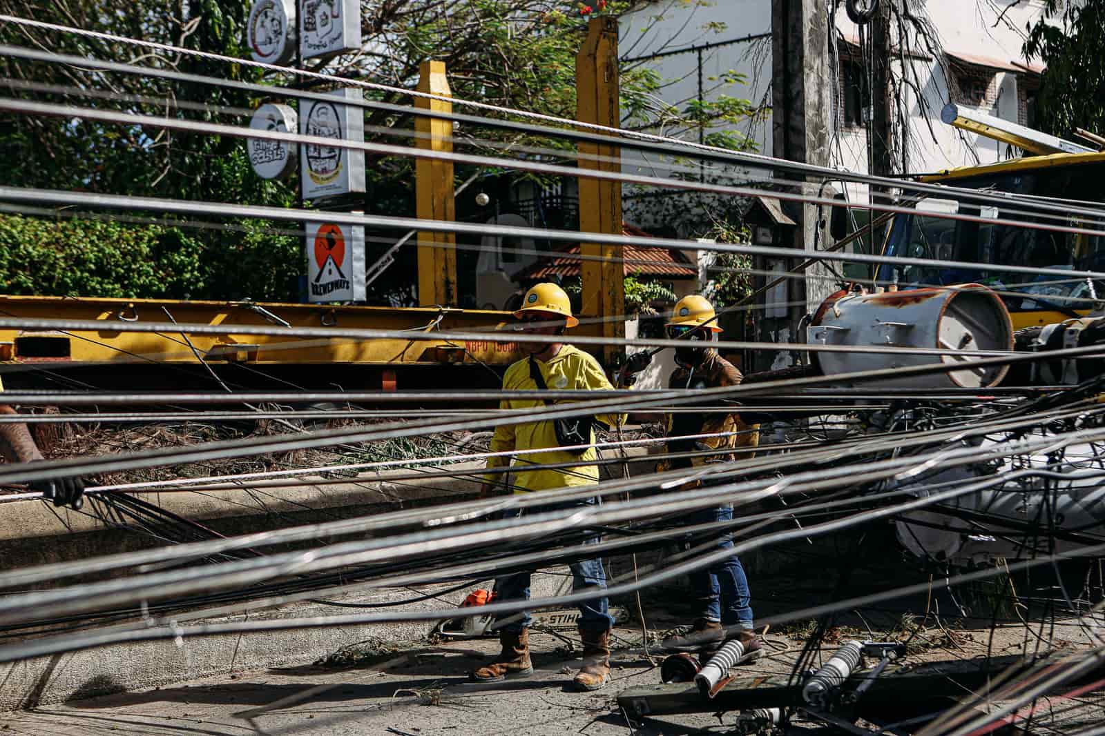 A long charging cable stretched across pavement