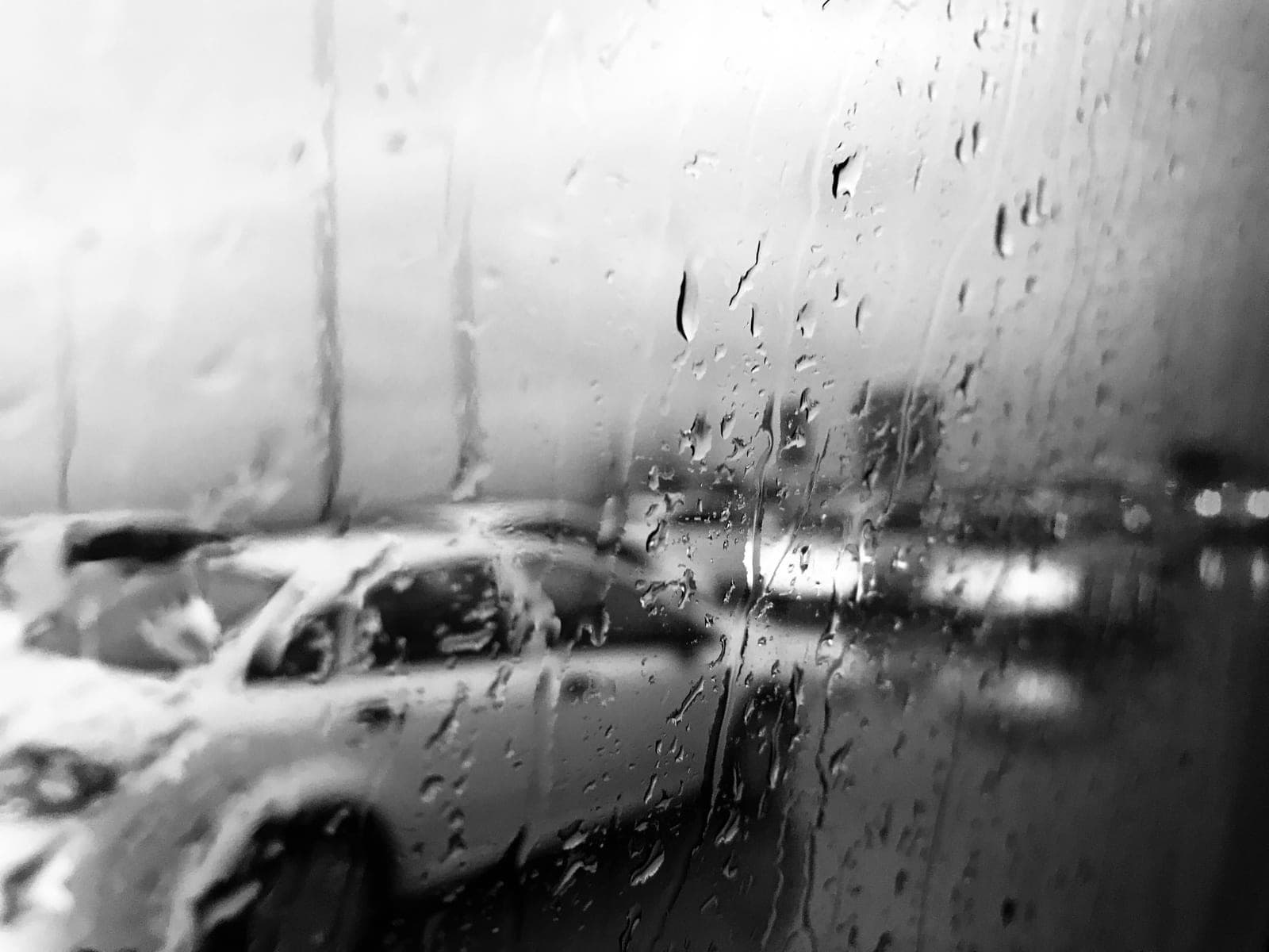 Rain water beaded on the surface of a car