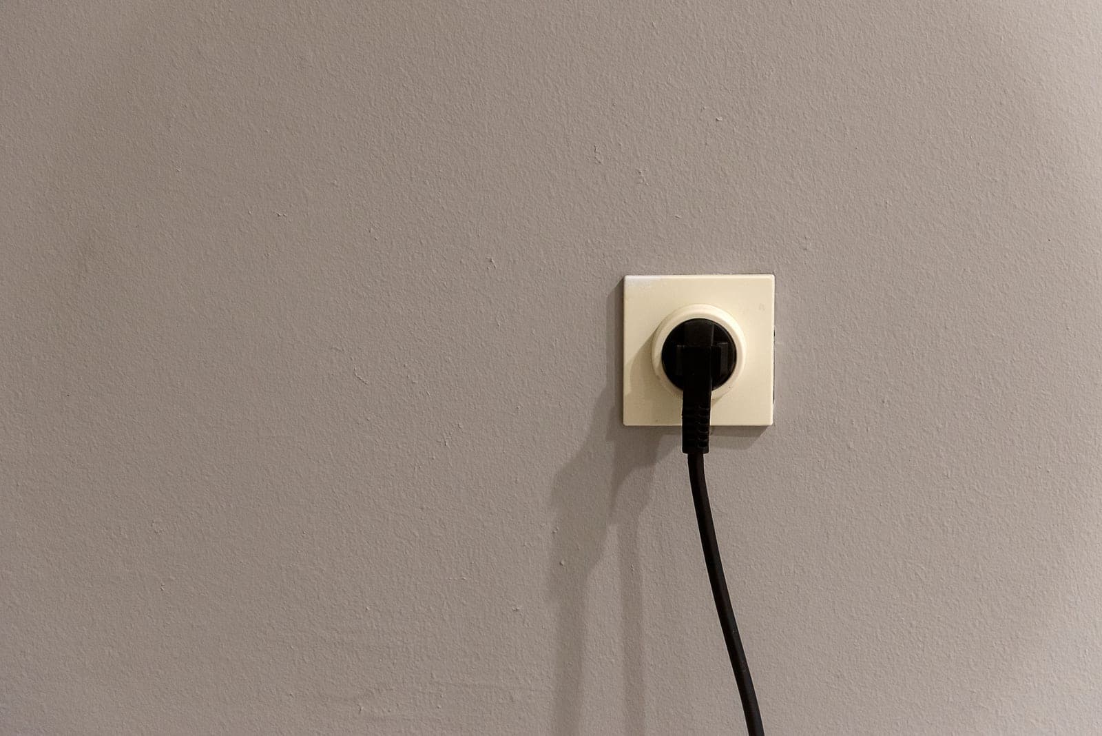 A damaged electrical outlet showing burn marks around the socket