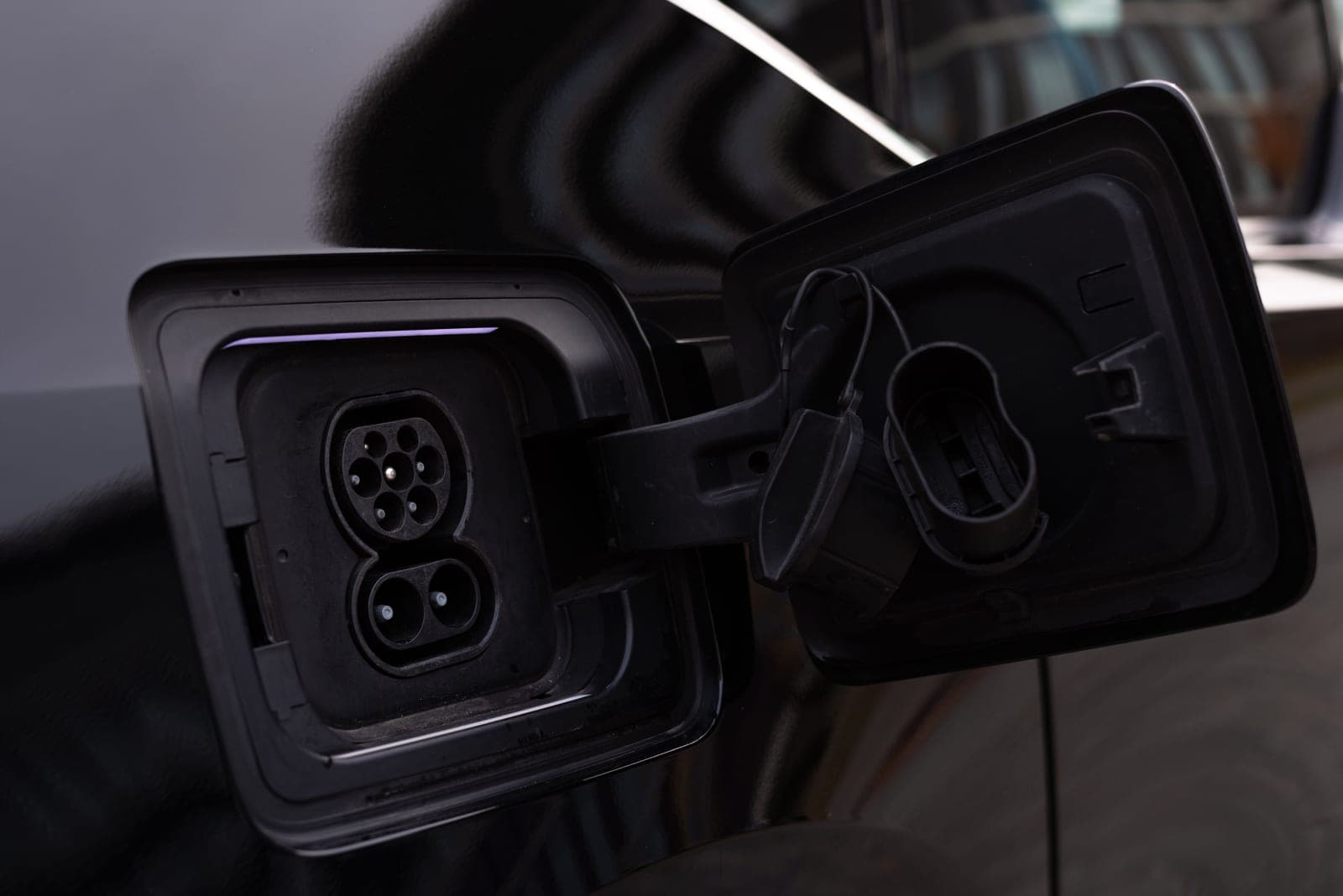 An open charging port on an electric car