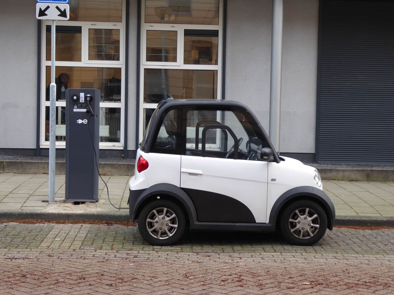 A public electric vehicle charging station in a parking bay