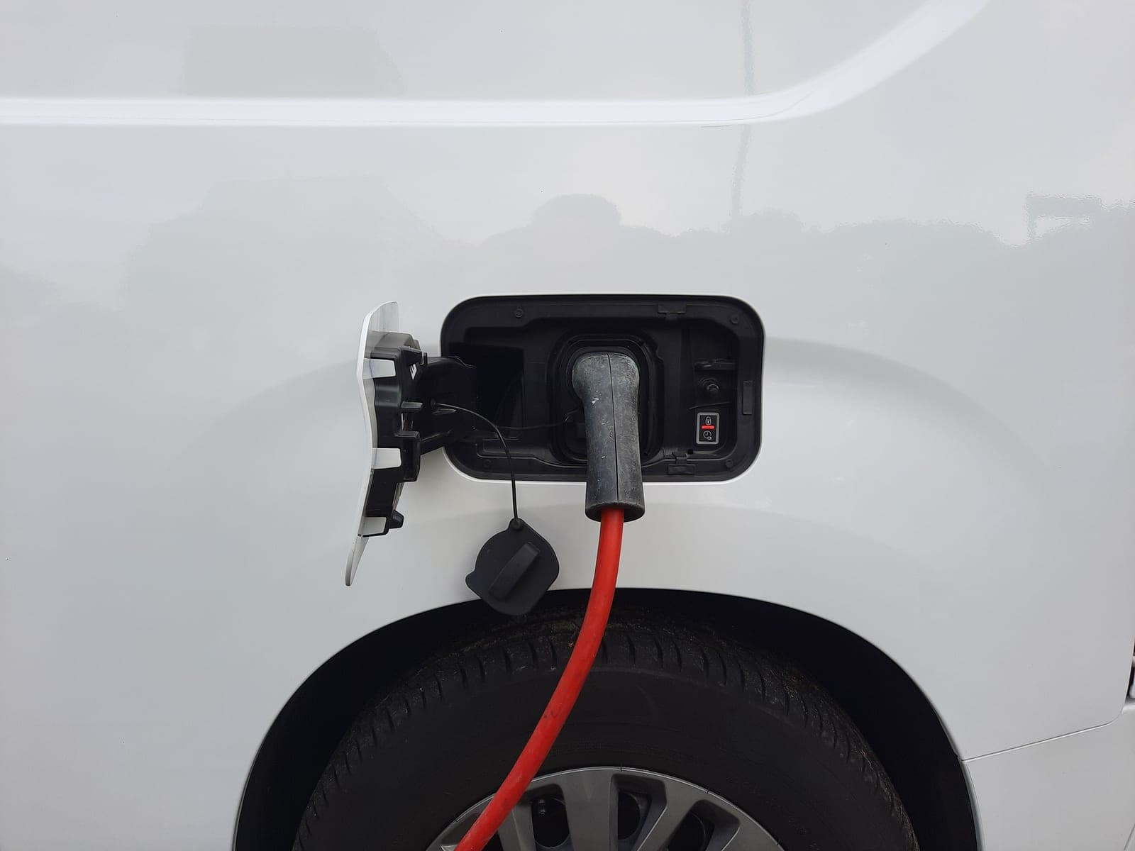 An electric car charging port with a cable attached