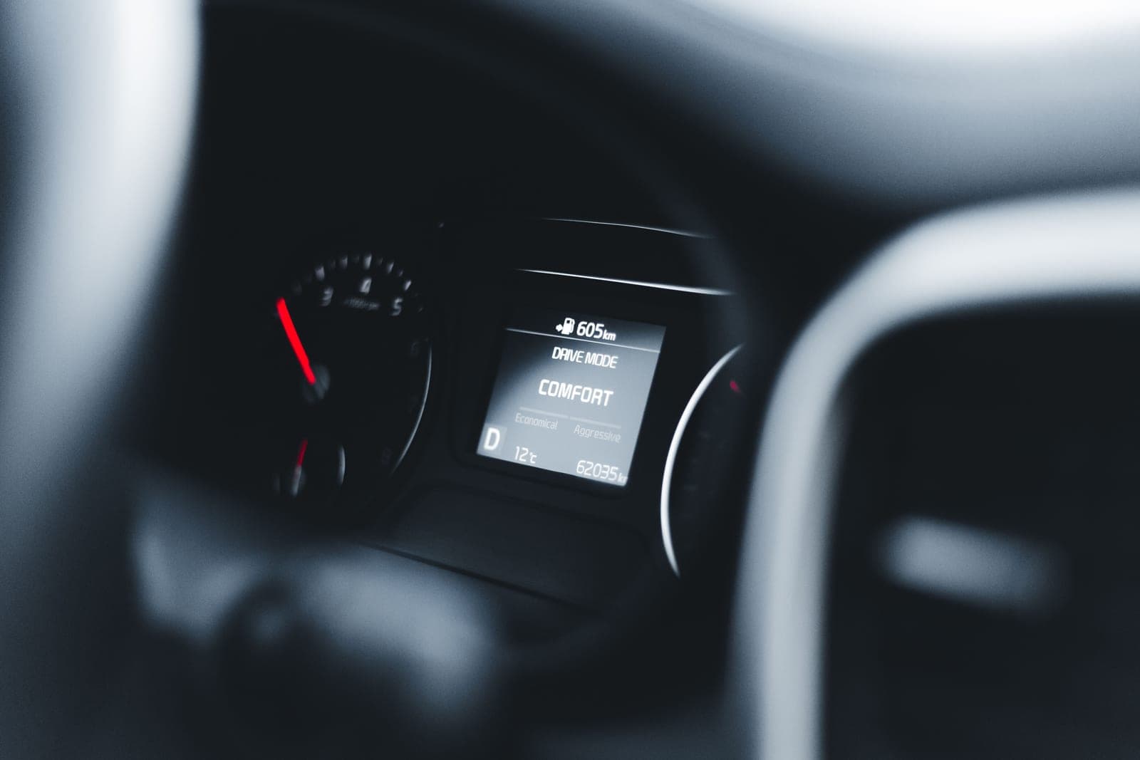 A car dashboard display showing charging status