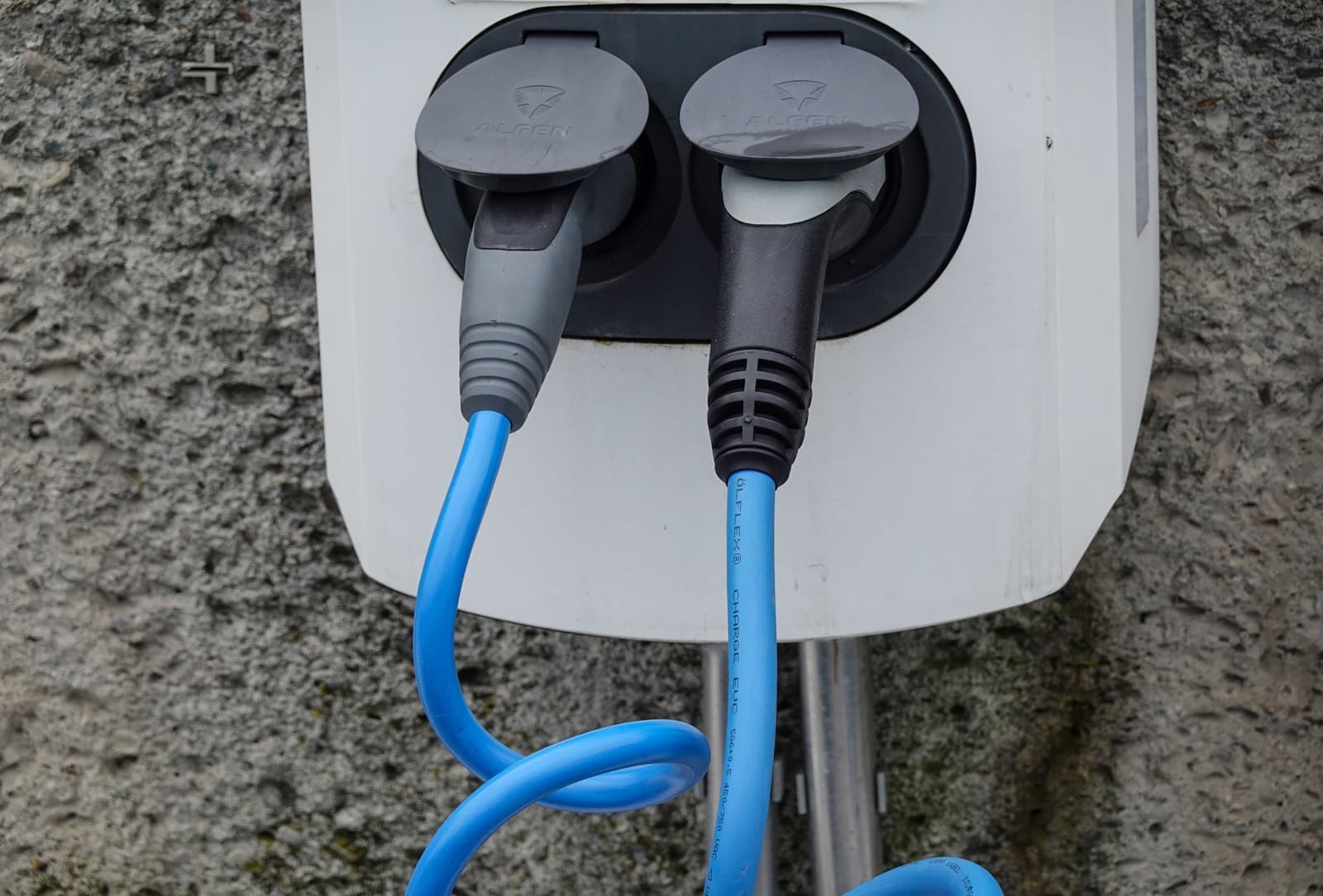 An electric vehicle charging cable plugged into an ordinary wall socket