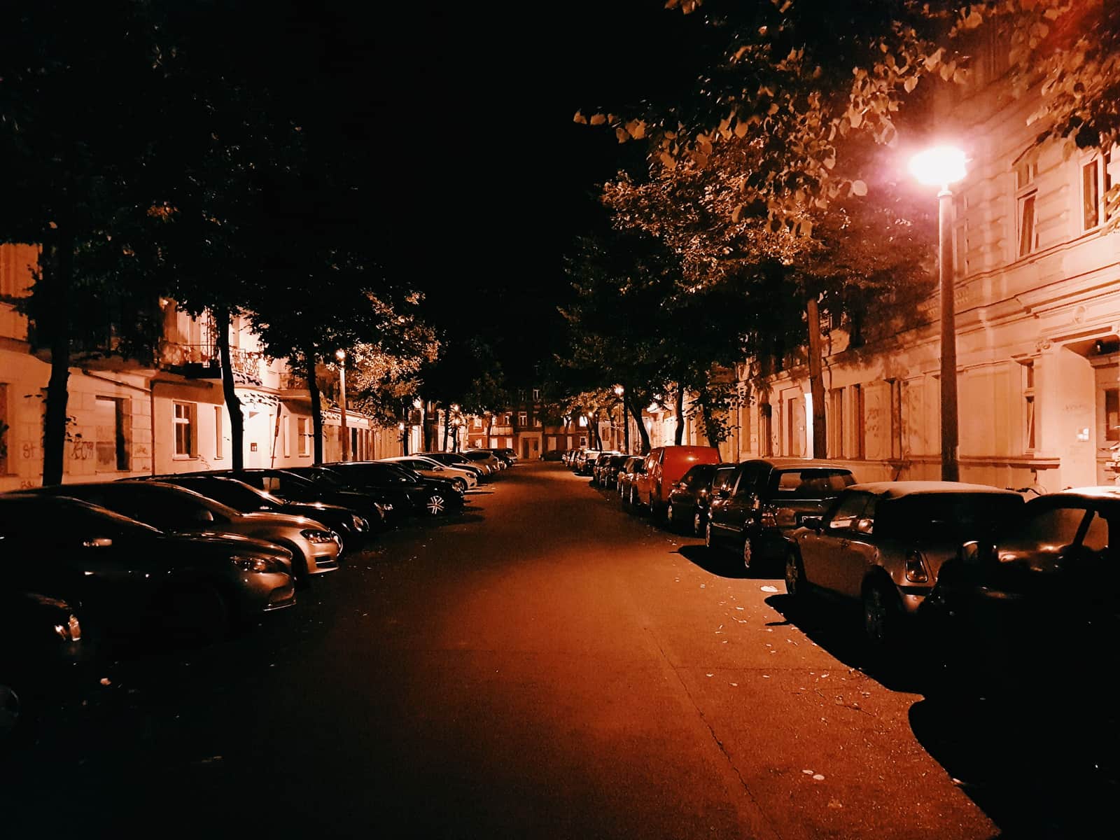 Cars parked along a residential street at night