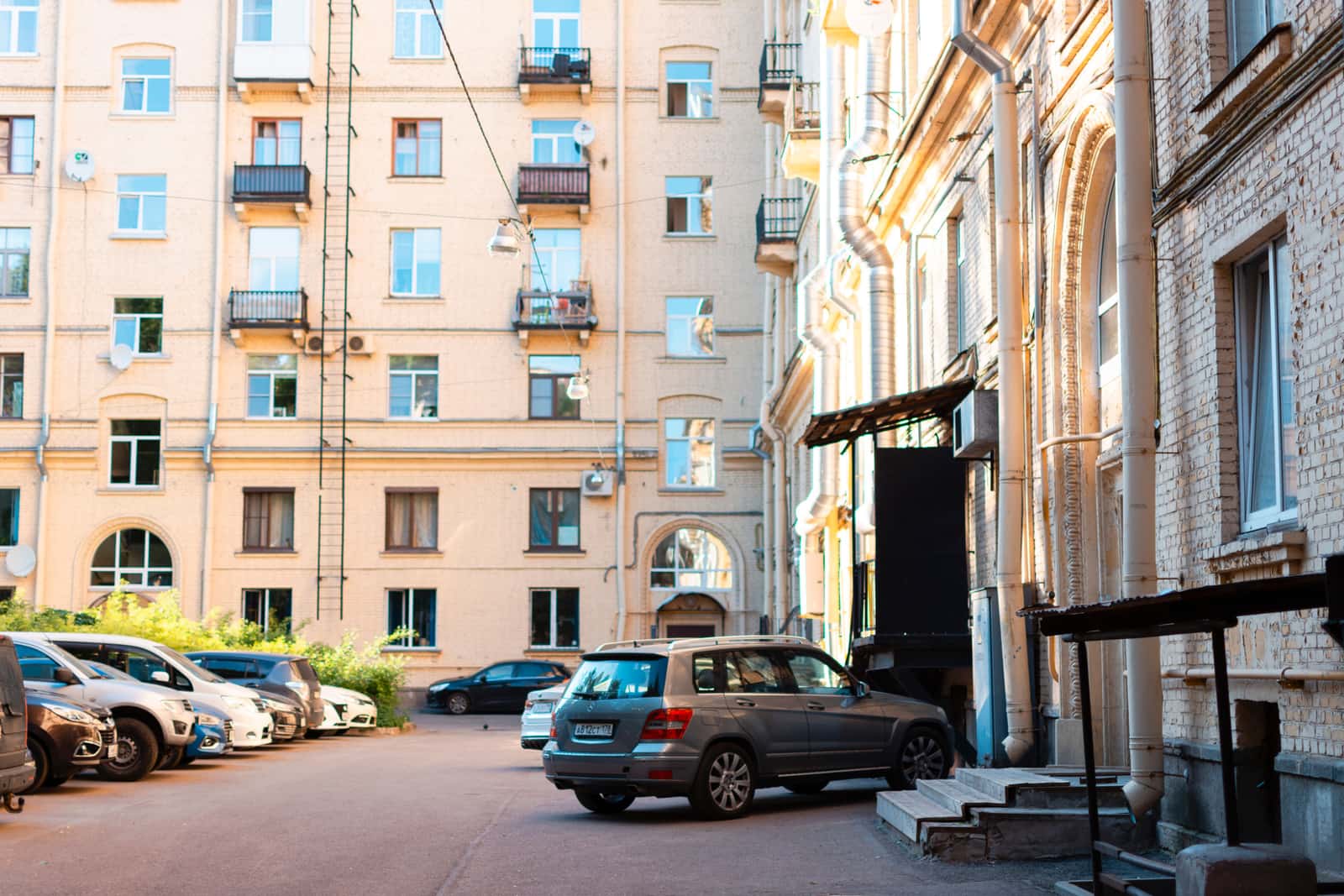 Cars parked in an open apartment complex lot with no garages