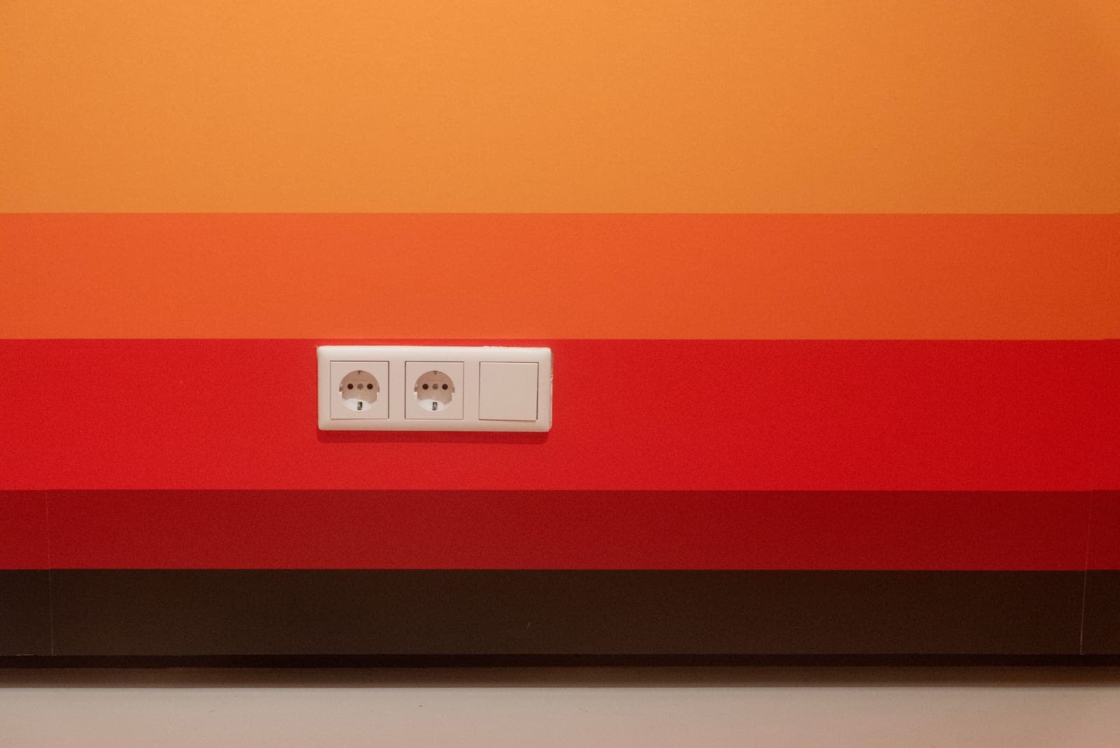 An electrical outlet on a wall, photographed close up