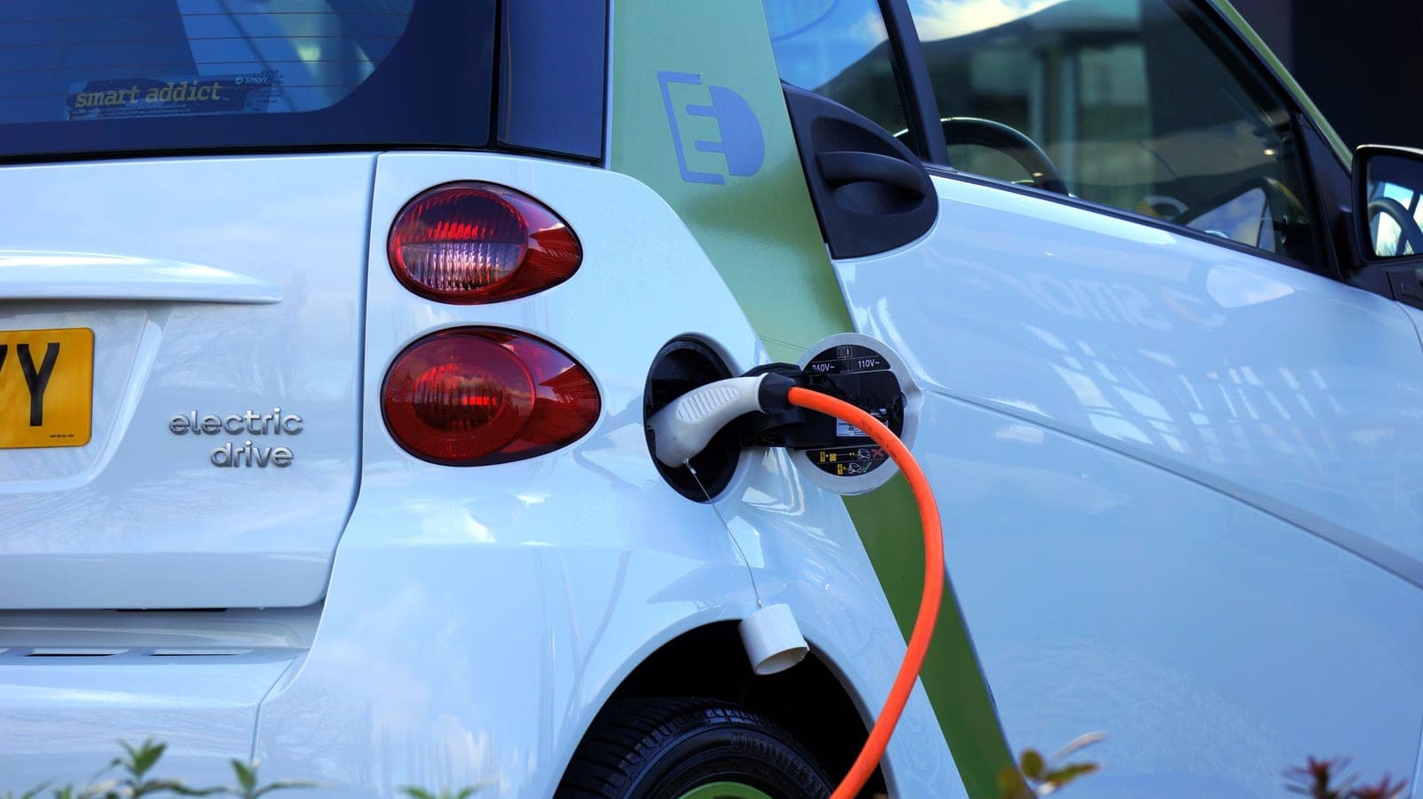 An electric vehicle charging cable plugged into a car