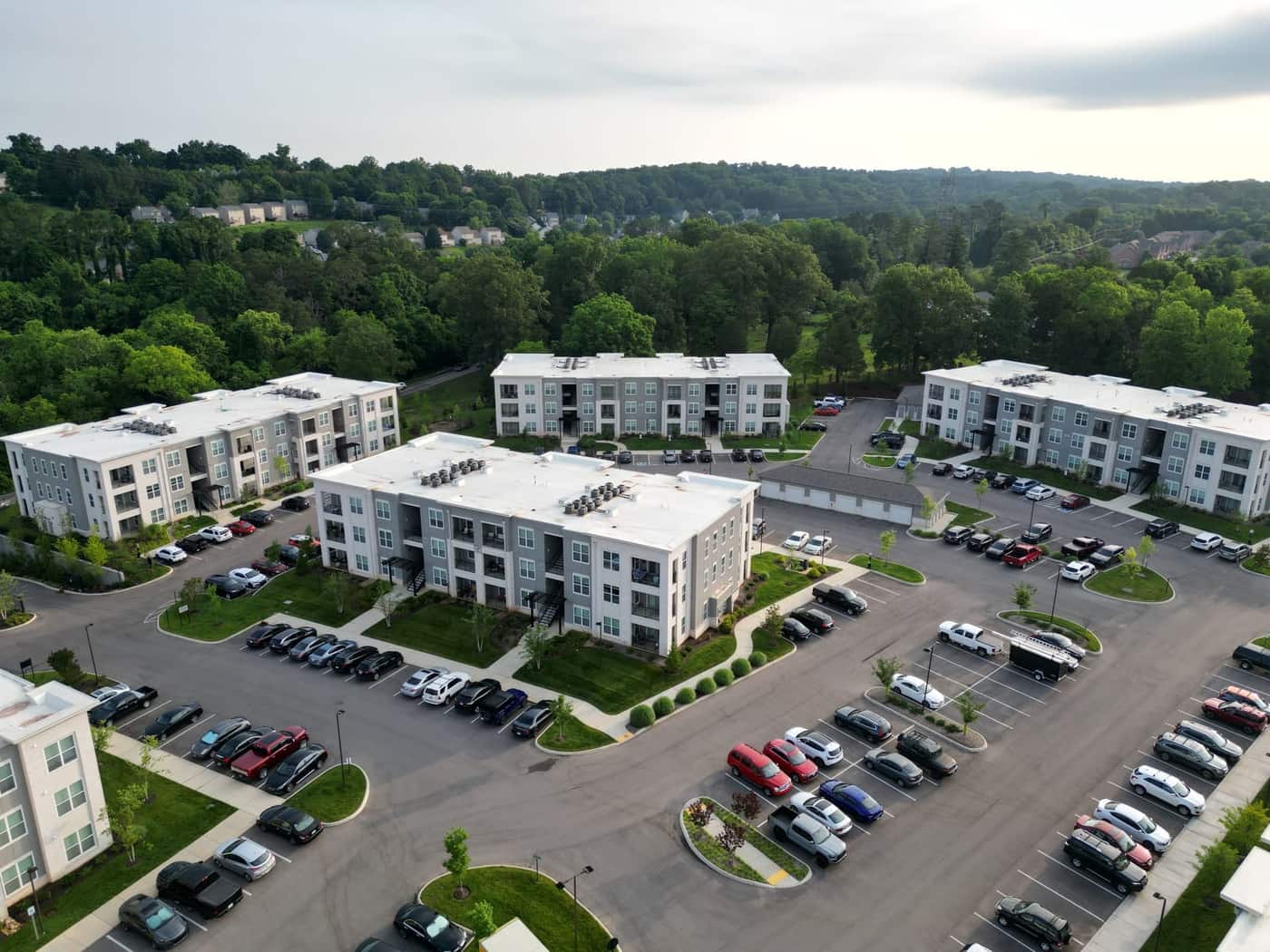 Aerial view of a US apartment complex with open surface parking lots