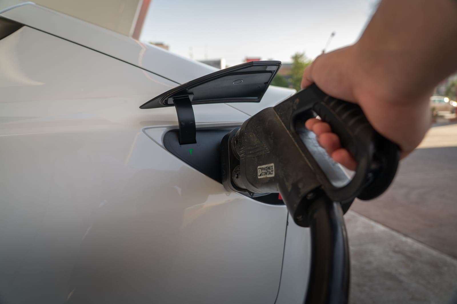 A person holding an electric vehicle charging cable