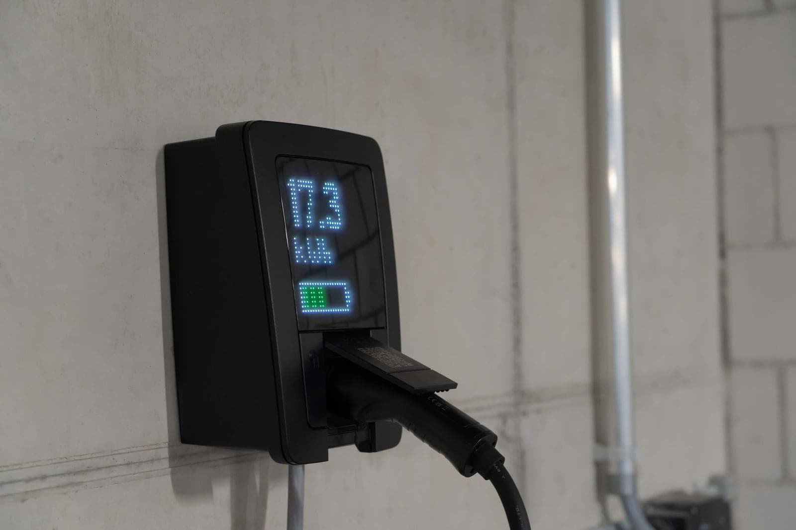 Close-up of EV charging equipment and its connector indoors