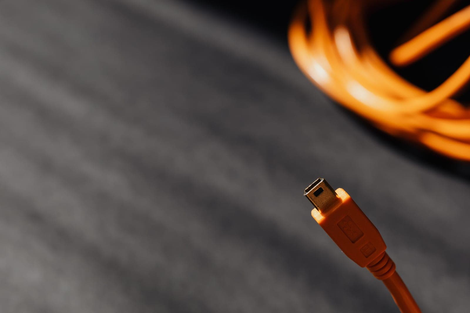 An electric vehicle charging cable and connector resting on the ground