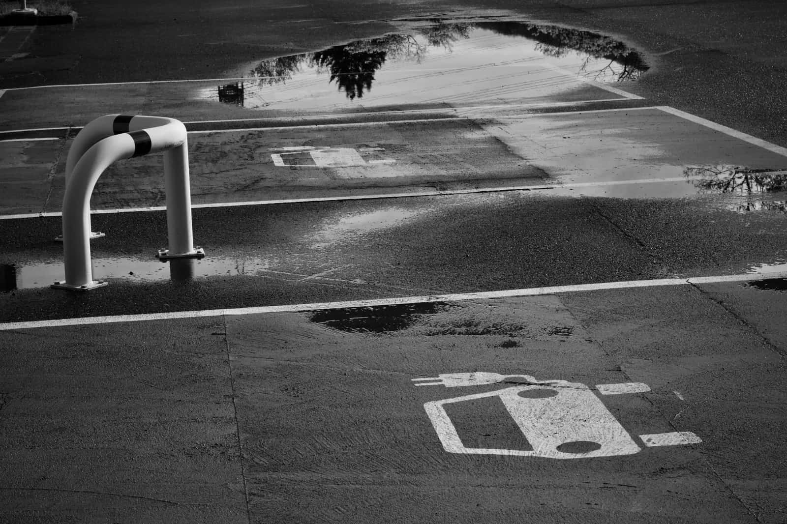 An electric car charging outdoors in wet weather