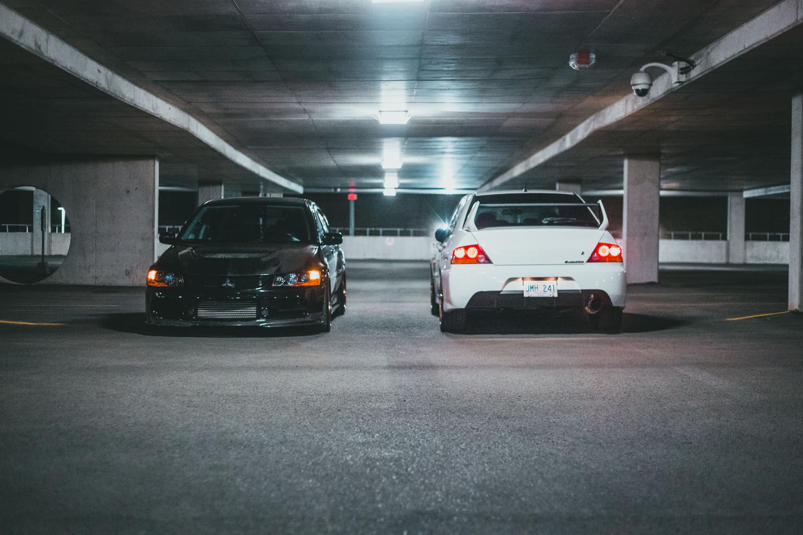 Cars parked in a dimly lit underground parking garage at night